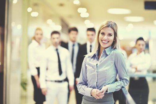 business woman  with her staff,  people group in background at modern bright office indoors