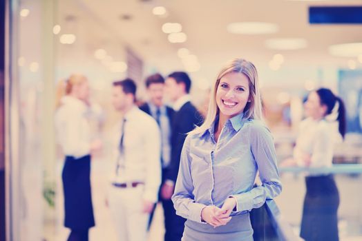 business woman  with her staff,  people group in background at modern bright office indoors