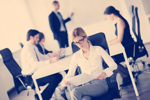 business woman  with her staff,  people group in background at modern bright office indoors