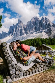Geisler Alm, Dolomites Italy, hiking in the mountains of Val Di Funes in Italian Dolomites,Nature Park Geisler-Puez with Geisler Alm in South Tyrol. Italy Europe, couple man and woman hiking mountains