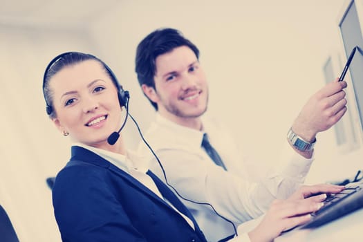 business people group with  headphones giving support in  help desk office to customers, manager giving training and education instructions