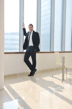 young business man lawyer with laptop alone in big bright   conference room