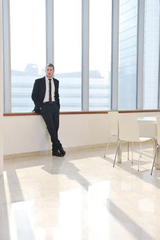 young business man lawyer with laptop alone in big bright   conference room