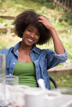 Portrait of Beautiful happy African-American girl sitting outside