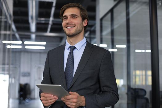 Young man using his tablet in the office.