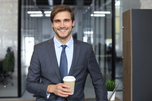 Young handsome businessman smiling in an office environment