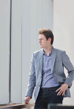 young business man lawyer with laptop alone in big bright   conference room