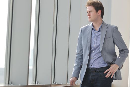 young business man lawyer with laptop alone in big bright   conference room