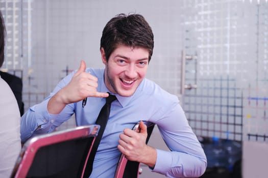 Portrait of a handsome young  business man  on a meeting in offce with colleagues in background