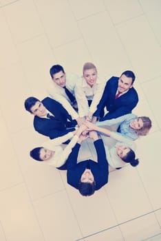 business people group joining hands and stay as team in circle  and representing concept of friendship and teamwork