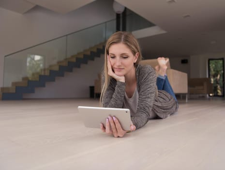 beautiful young women used tablet computer on the floor of her luxury home