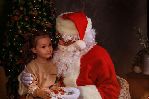 Santa Claus and child at home. Christmas gift. Family holiday concept