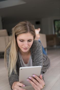 beautiful young women used tablet computer on the floor of her luxury home