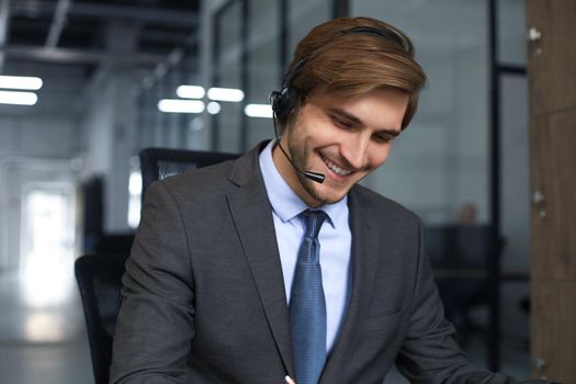 Smiling friendly handsome young male call centre operator