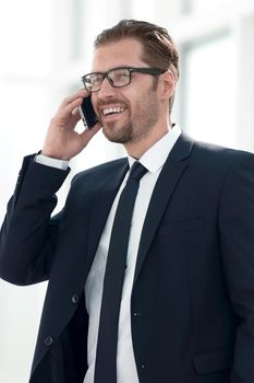 confident businessman talking on mobile phone. the concept of communication