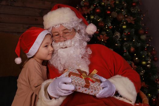 Santa Claus and child at home. Christmas gift. Family holiday concept