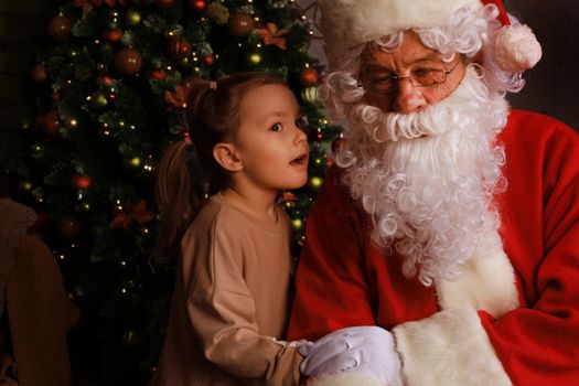 Santa Claus and child at home. Christmas gift. Family holiday concept