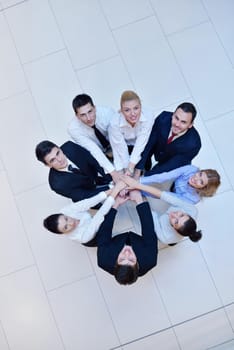 business people group joining hands and stay as team in circle  and representing concept of friendship and teamwork