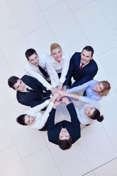 business people group joining hands and stay as team in circle  and representing concept of friendship and teamwork