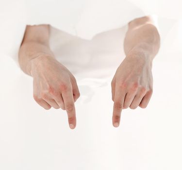 man is breaking through a paper wall and pointing at you.photo with copy space