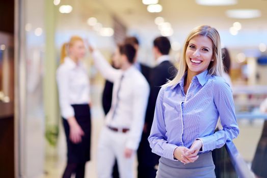 business woman  with her staff,  people group in background at modern bright office indoors