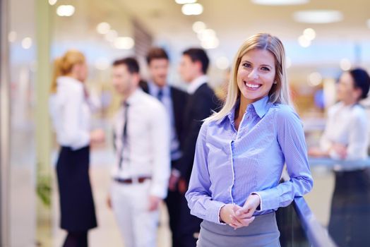 business woman  with her staff,  people group in background at modern bright office indoors