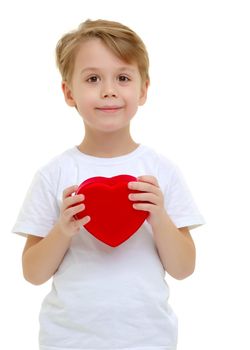 A little boy is smiling with a red heart figure. Symbol of love, family, hope. Background to the Valentine's day. Isolated on white background.