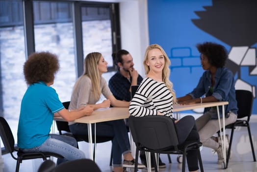 Multiethnic startup business team on meeting in modern bright office interior brainstorming, working on laptop and tablet computer