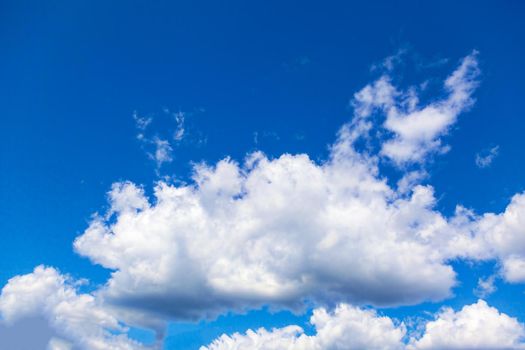 Thick cumulus clouds against a blue sky.