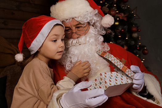 Santa Claus and child at home. Christmas gift. Family holiday concept