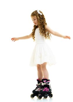 Cute little girl fun rollerblading. The concept of a healthy lifestyle, advertising. Isolated on white background.