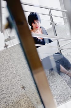 senior business woman work on laptop at modern staircase