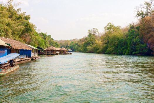 The concept of family tourism. Floating tourist huts on the river Kwai, Thailand.