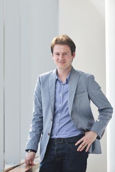 young business man lawyer with laptop alone in big bright   conference room