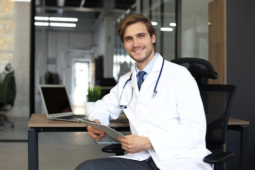 Portrait of smiling excited doctor in hospital