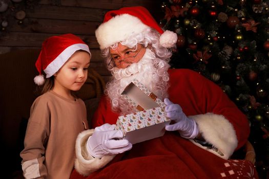 Santa Claus and child at home. Christmas gift. Family holiday concept