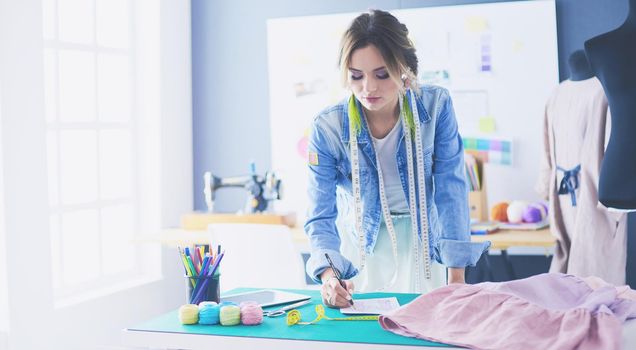 Fashion designer woman working on her designs in the studio.