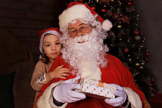 Santa Claus and child at home. Christmas gift. Family holiday concept