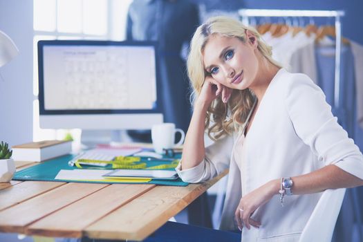Fashion designer woman working on her designs in the studio