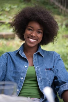 Portrait of Beautiful happy African-American girl sitting outside