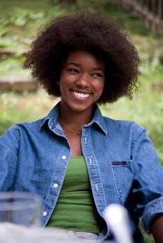 Portrait of Beautiful happy African-American girl sitting outside