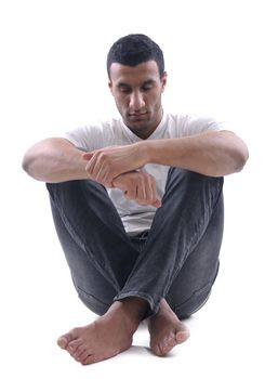 portrait of relaxed young man dressed in white shirt and jeans isolated over white background in studio