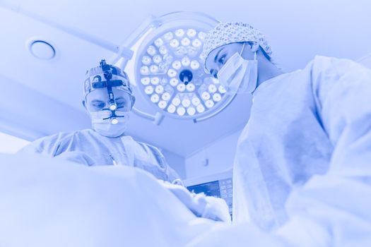 Man surgeon at work in operating room.