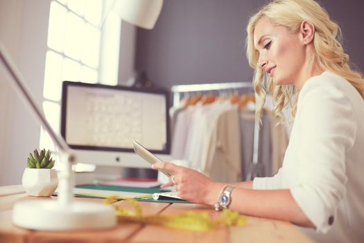 Fashion designer woman working on her designs in the studio