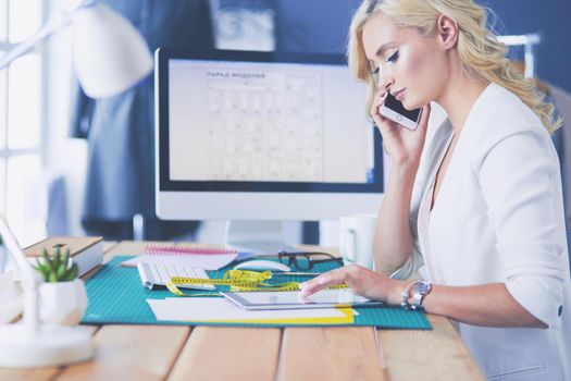 Fashion designer woman working on her designs in the studio