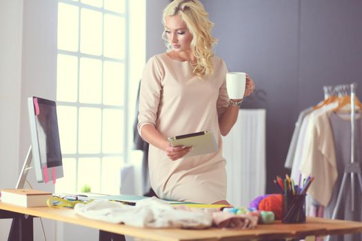 Fashion designer woman working on her designs in the studio