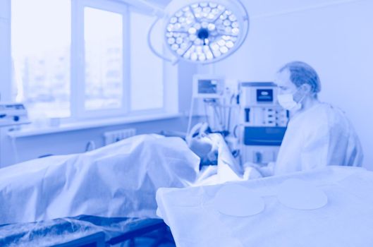 Man surgeon at work in operating room.