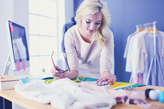Fashion designer woman working on her designs in the studio