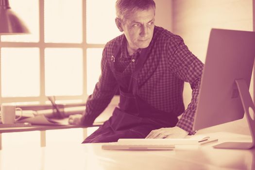 Architect working on drawing table in office.