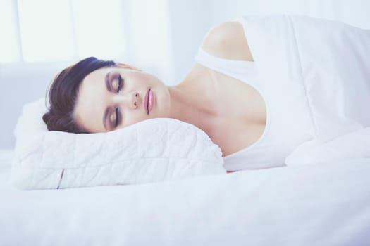 Young beautiful woman lying in bed